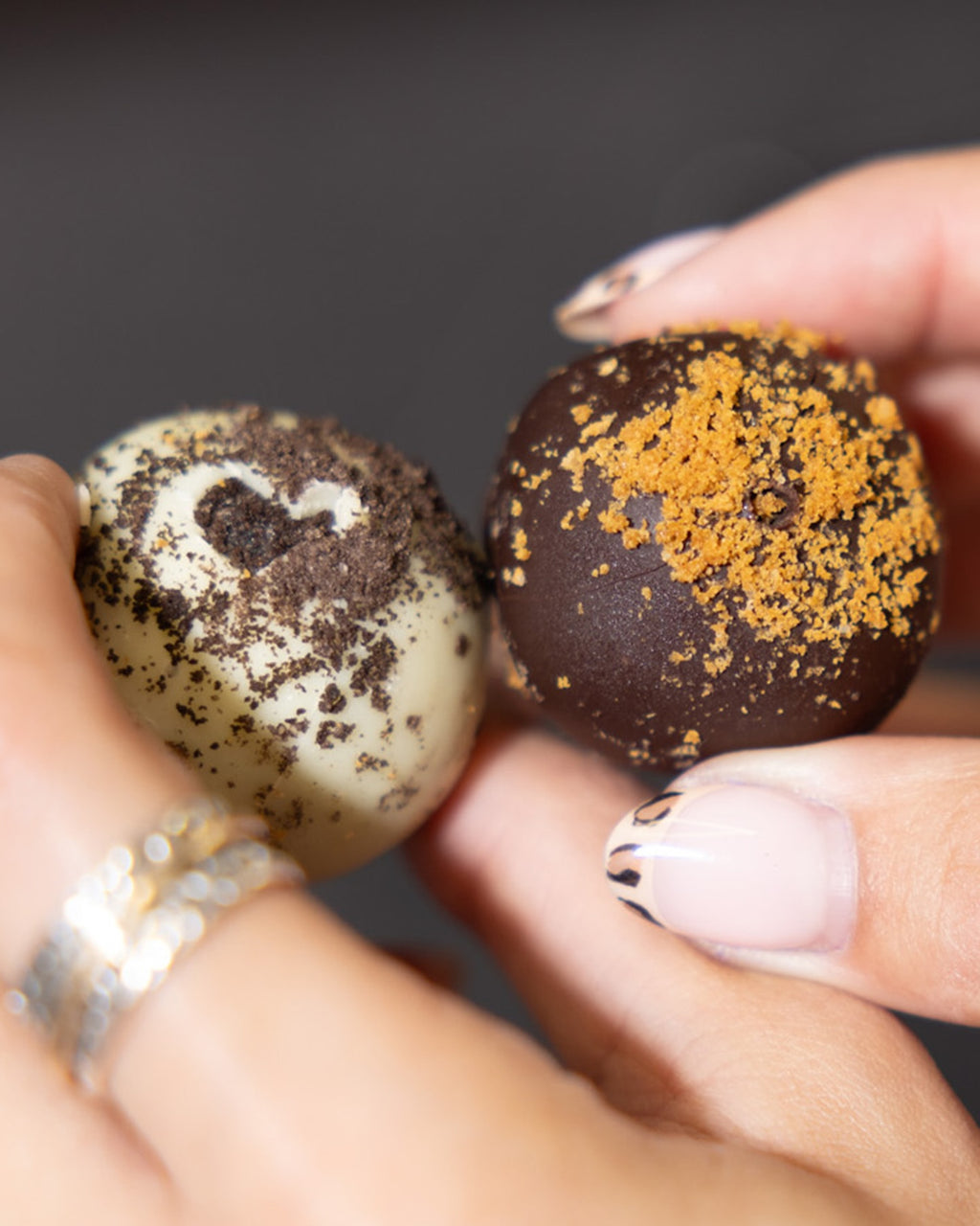 One Oreo and one Biscoff Protein Ball held side by side
