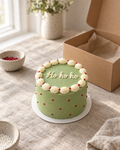 Ho Ho Ho Bento, a small green buttercream bento cake with a white shell border, red dots and Ho ho ho piped on top