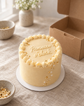 Prosecco O'Clock Bento: a 4 inch bento cake in smooth pale gold buttercream with a cream ruffled border, edible gold leaf flecks and a few sugar pearls like bubbles rising up the side