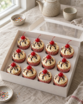 Cherry Sundae Cupcakes: twelve cupcakes in red and white striped paper cases, each with a tall swirl of vanilla buttercream like soft-serve, a drizzle of chocolate sauce, rainbow sprinkles and a red glacé cherry with a stem on top