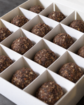 A box of 16 Energy protein balls, dark brown with a rough, textured outside