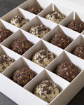 A box of Oreo and Energy protein balls: white chocolate balls with Oreo crumb next to dark brown textured Energy balls
