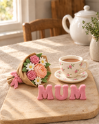 Mother's Day Bouquet and Teacup Cake Topper Set laid out on a wooden board