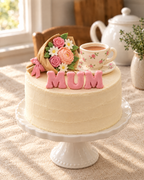 Mother's Day Bouquet and Teacup Cake Topper Set on top of a cream cake