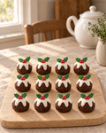 12 Christmas Pudding Cupcake Toppers laid out on a wooden board