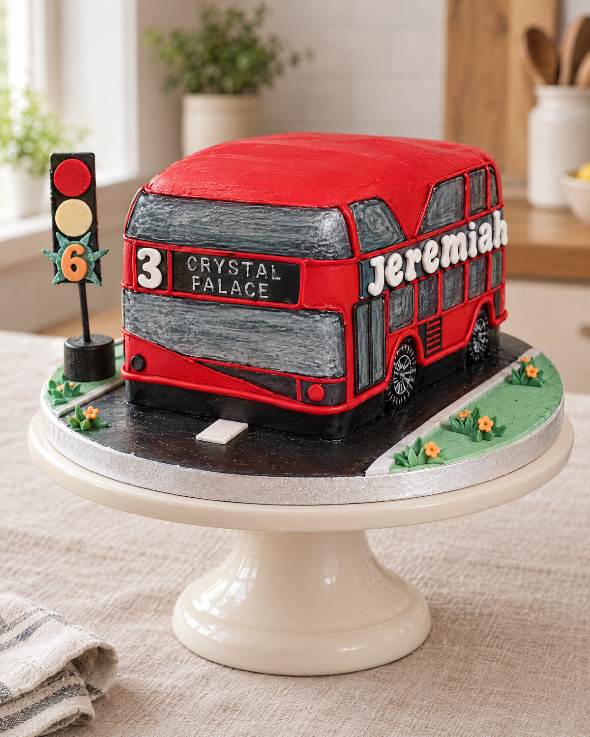 London Bus Cake: red double-decker reading 3 CRYSTAL PALACE, Jeremiah on the side, on a road board with a traffic light