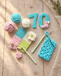 Crochet and Yarn Cake Topper Set laid flat on a wooden board