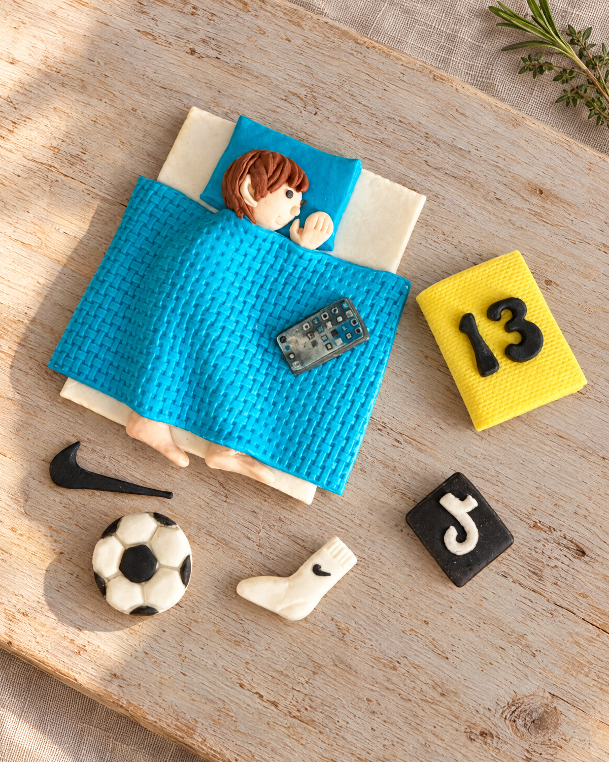Teenager in Bed Cake Topper Set laid flat on a wooden board