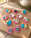 Make-Up and Fashion Cupcake Toppers laid out on a wooden board