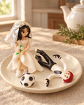 Footballer Bride and Groom Wedding Cake Topper on a cream plate