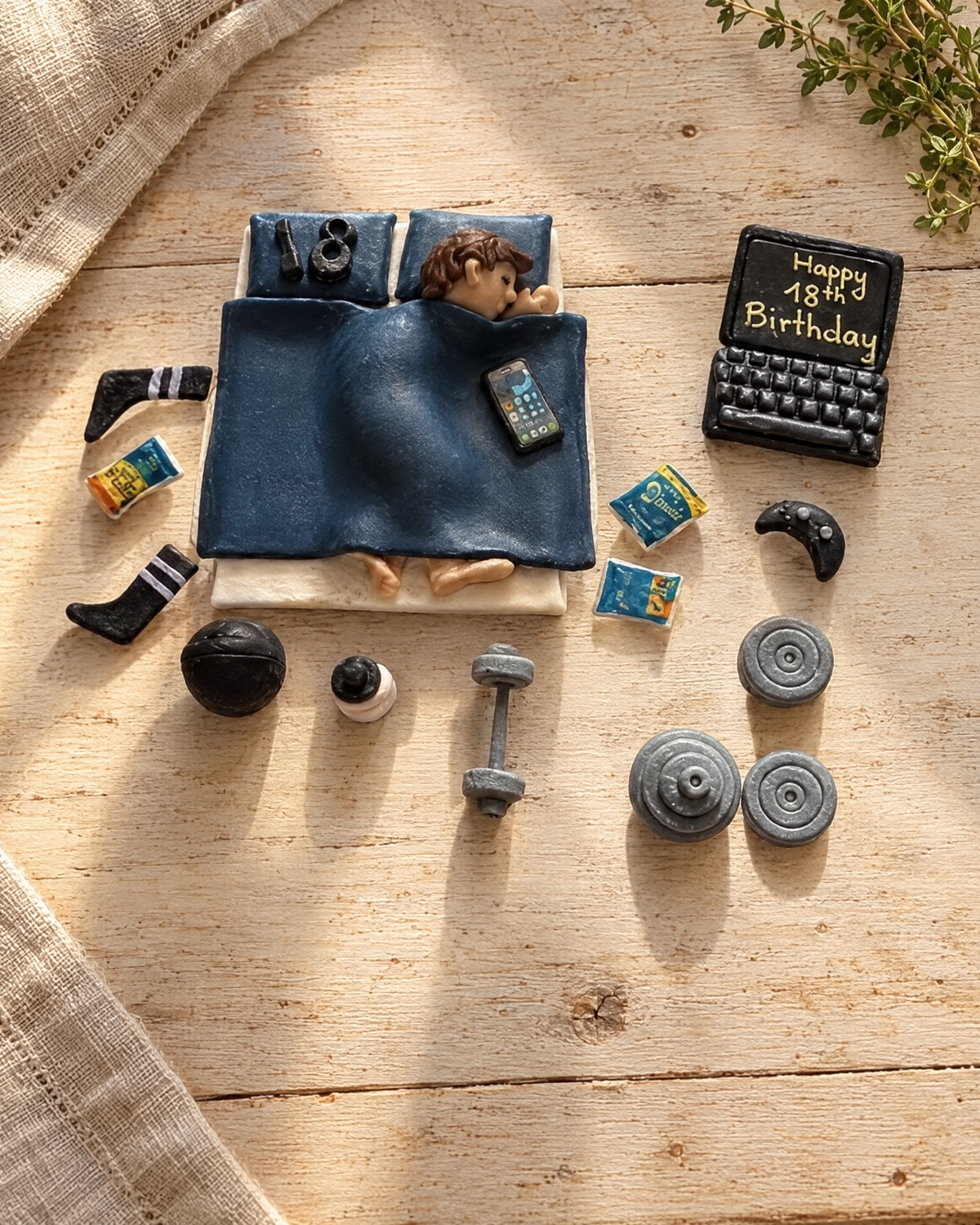 Teenager in Bed with Laptop Cake Topper laid flat on a wooden board