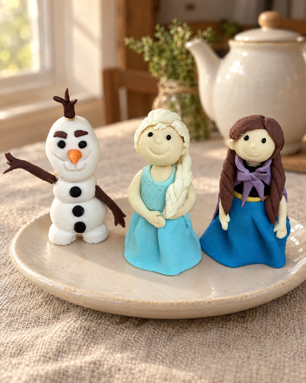 Frozen Fondant Figure Cake Topper on a linen tablecloth