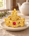 Large Gold Tiara Crown Cake Topper on a cream plate