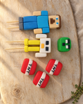 Minecraft Cake Topper Set laid flat on a wooden board