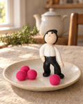 Bowls Player and Bowls Cake Topper on a cream plate
