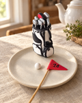 Golf Bag, Ball and Flag Cake Topper on a cream plate