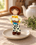 Jessie Figure Cake Topper on a cream plate