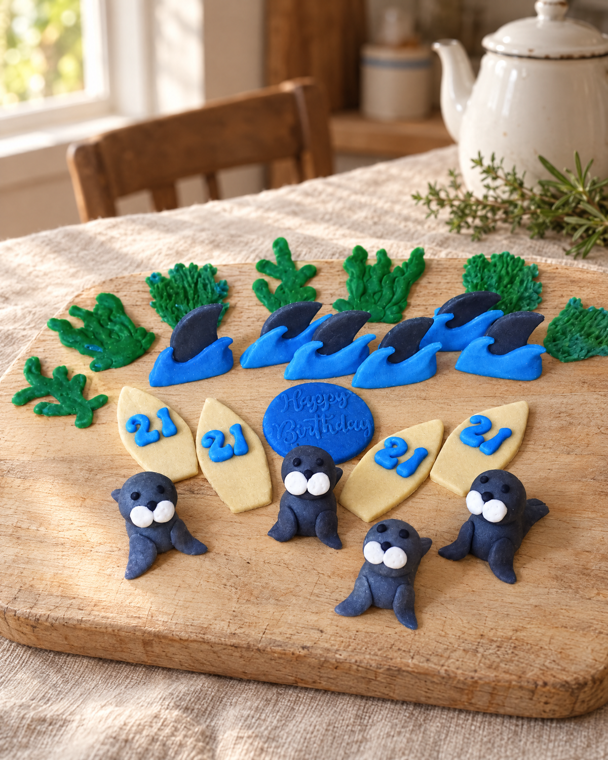 10 Sea Life Cupcake Toppers laid out on a wooden board