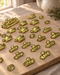 Crowns and Coins Cake Topper Set laid out on a wooden board