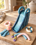 Pool Party Slide Cake Topper Set laid out on a wooden board