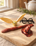 Harry Potter Inspired Cake Topper Set laid out on a wooden board