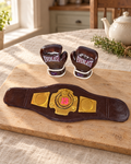 Boxing Gloves and Champion Belt Cake Topper laid out on a wooden board