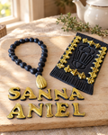 Prayer Beads and Mat Personalised Cake Topper laid out on a wooden board