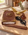 Harry Potter Book Cake Topper Set laid out on a wooden board