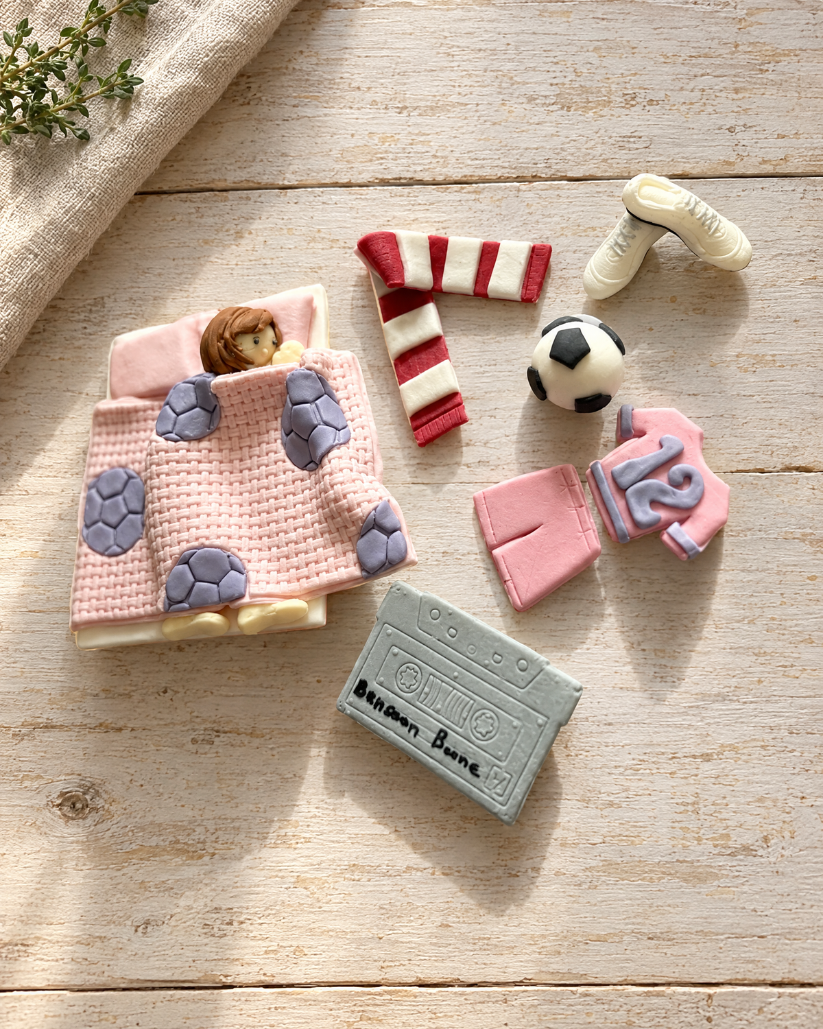 Football Bedroom Cake Topper Set laid flat on a wooden board